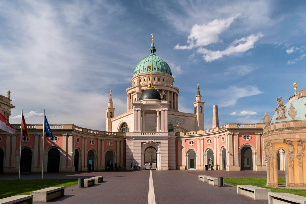 Pink palace courtyard with the green dome of St Nicholas’ Church