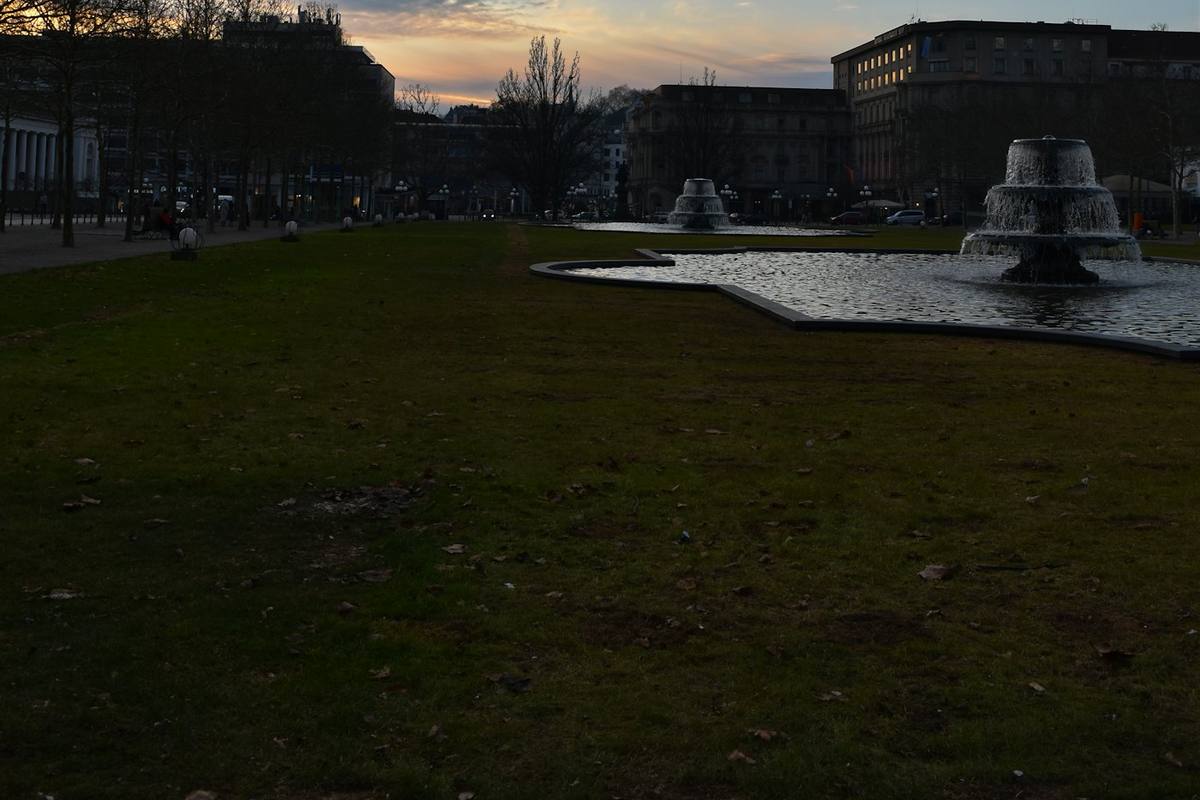 Lawn with fountains in front of the Kurhaus at dusk